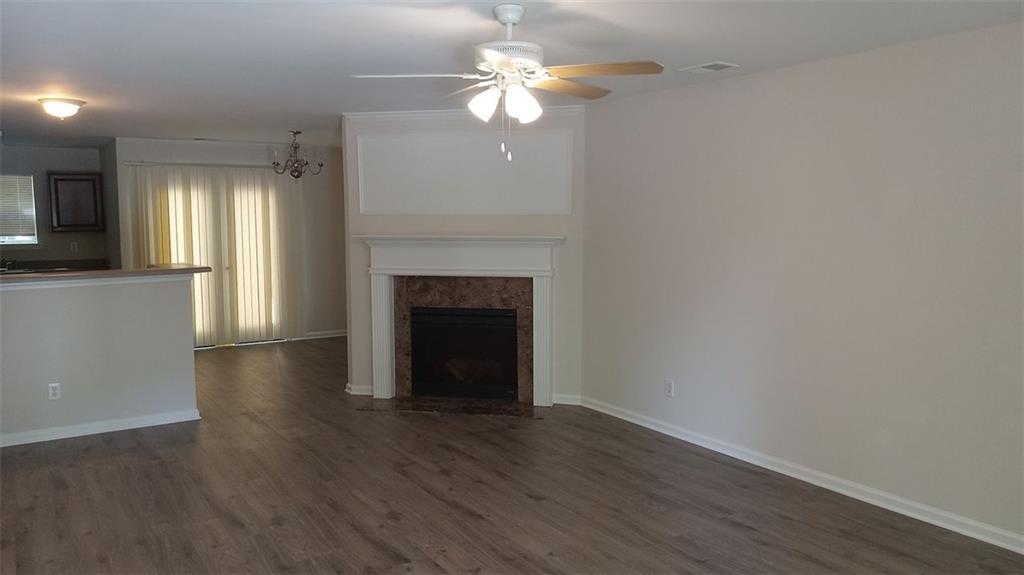 755 Crestwell Circle Atlanta, GA 30331 - Photo 3 of 29 a view of a livingroom with a fireplace a ceiling fan and wooden floor