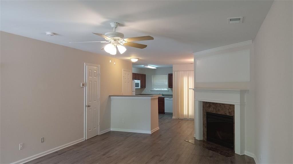 755 Crestwell Circle Atlanta, GA 30331 - Photo 4 of 29 a view of a kitchen with a sink a fireplace and wooden floor