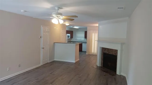 a view of a kitchen with a sink a fireplace and wooden floor