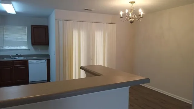 a view of a kitchen with a sink and dishwasher