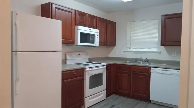 a kitchen with kitchen island a sink stainless steel appliances and cabinets