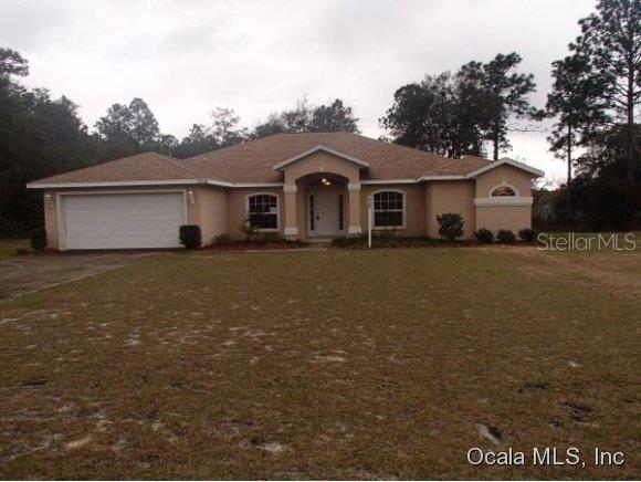 12730 Southwest 64th Lane Ocala, FL 34481 - Photo 1 of 1 a view of a yard in front of a house with a large tree