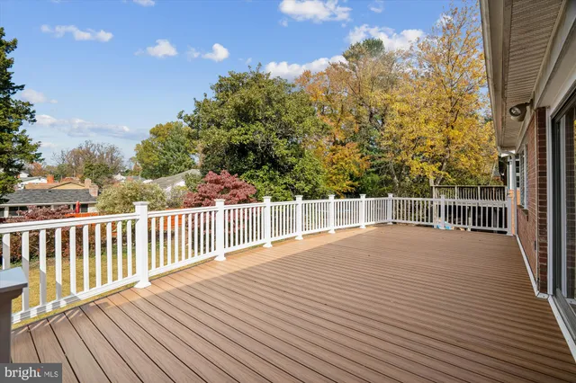 a view of a balcony with wooden floor and fence