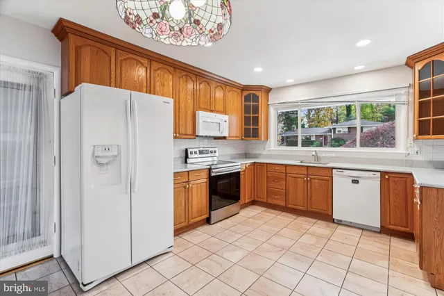 a kitchen with stainless steel appliances granite countertop a sink and cabinets