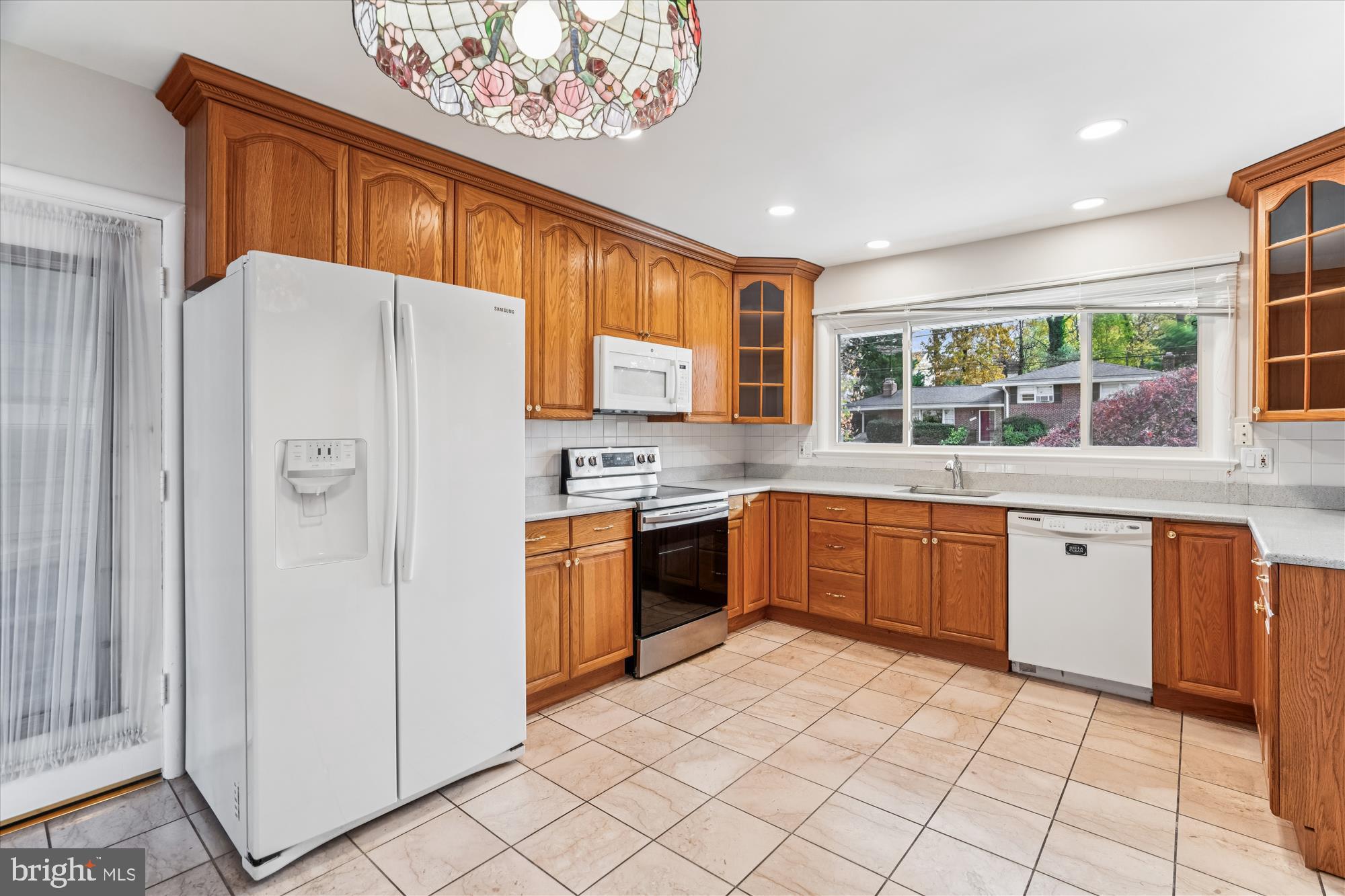 5813 Midhill Street Bethesda, MD 20817 - Photo 18 of 55 a kitchen with stainless steel appliances granite countertop a refrigerator sink and cabinets