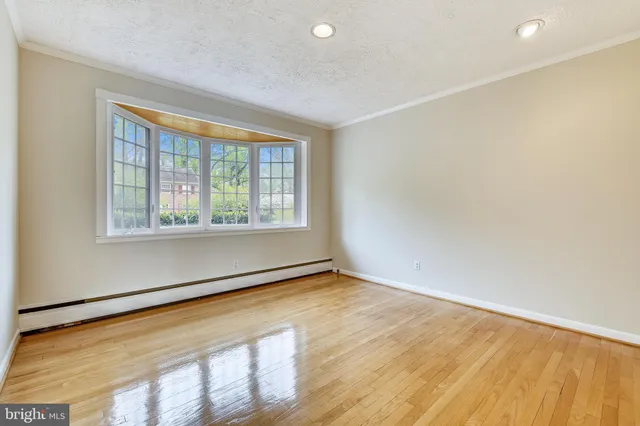 a view of a room with wooden floor and a bathroom