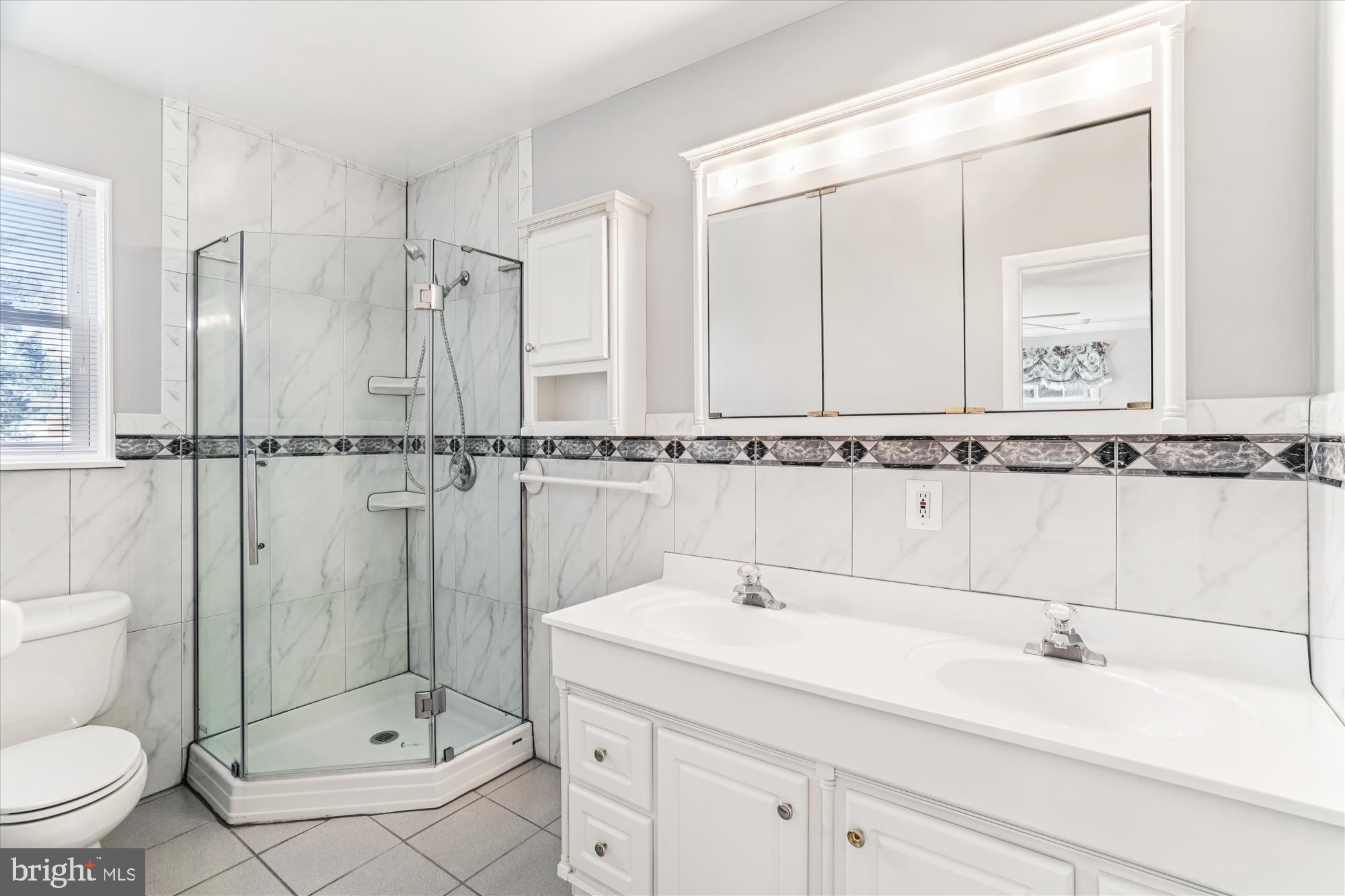 5813 Midhill Street Bethesda, MD 20817 - Photo 25 of 55 a bathroom with a sink a toilet and shower
