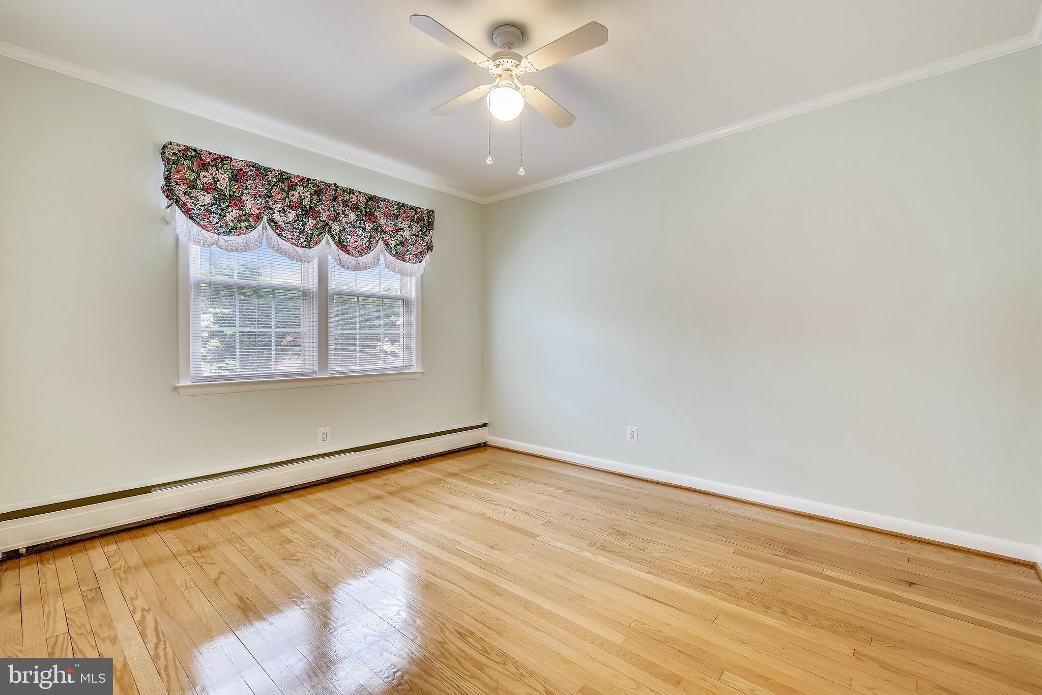 5813 Midhill Street Bethesda, MD 20817 - Photo 26 of 55 an empty room with windows and fan