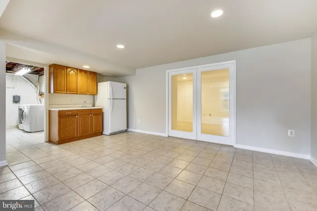 a view of a kitchen with a sink and a refrigerator