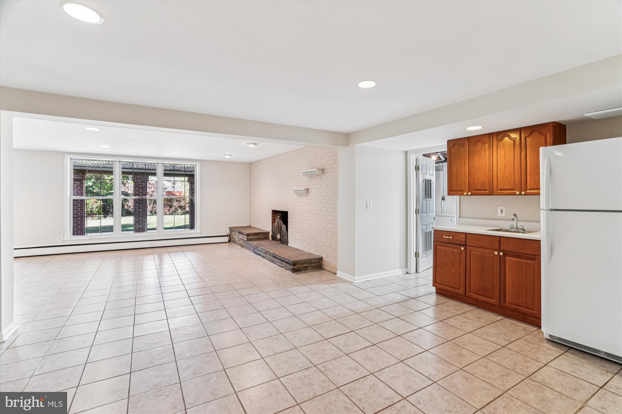 5813 Midhill Street Bethesda, MD 20817 - Photo 32 of 55 a view of a kitchen with a sink and a refrigerator