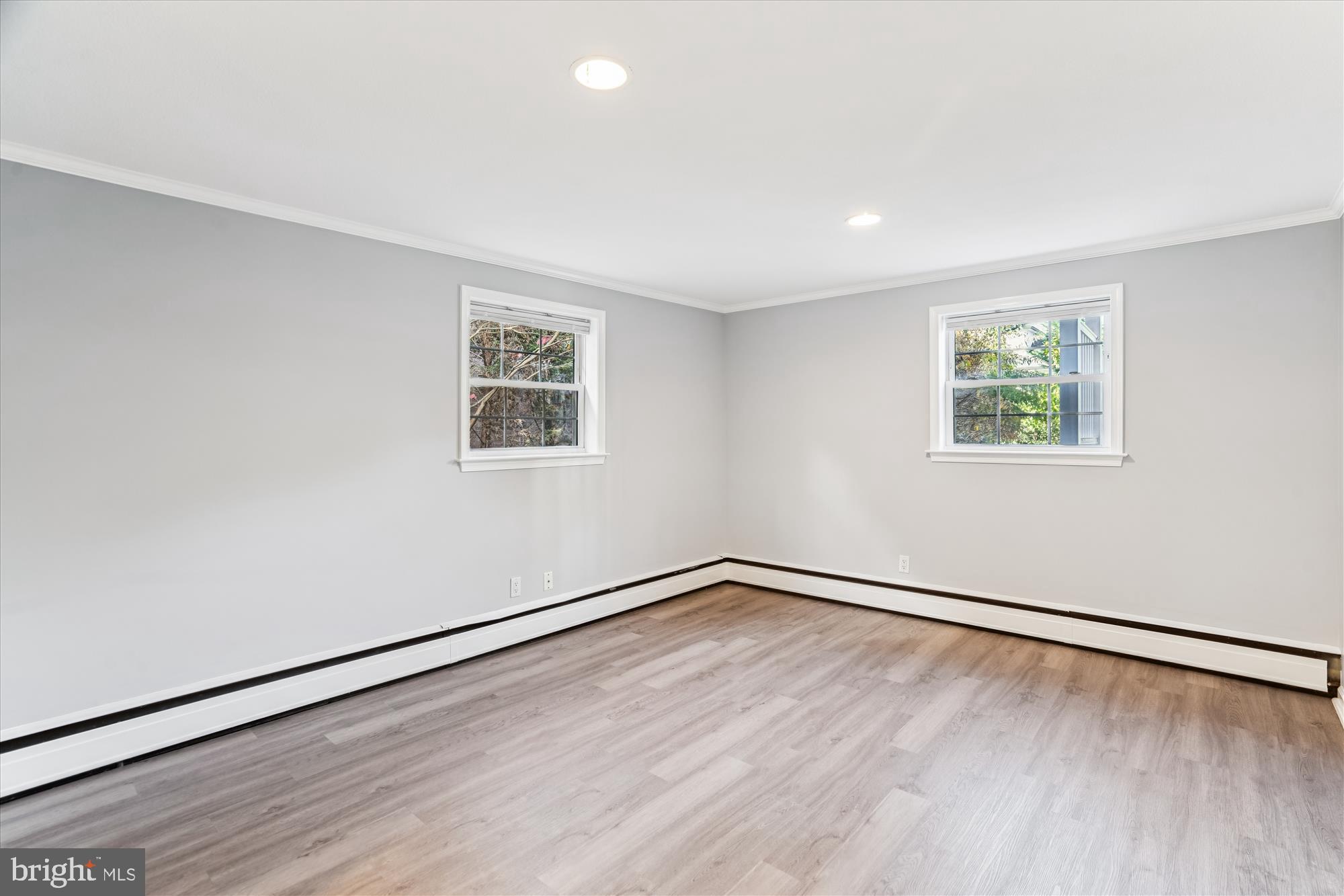 5813 Midhill Street Bethesda, MD 20817 - Photo 36 of 55 a view of an empty room with wooden floor and a window