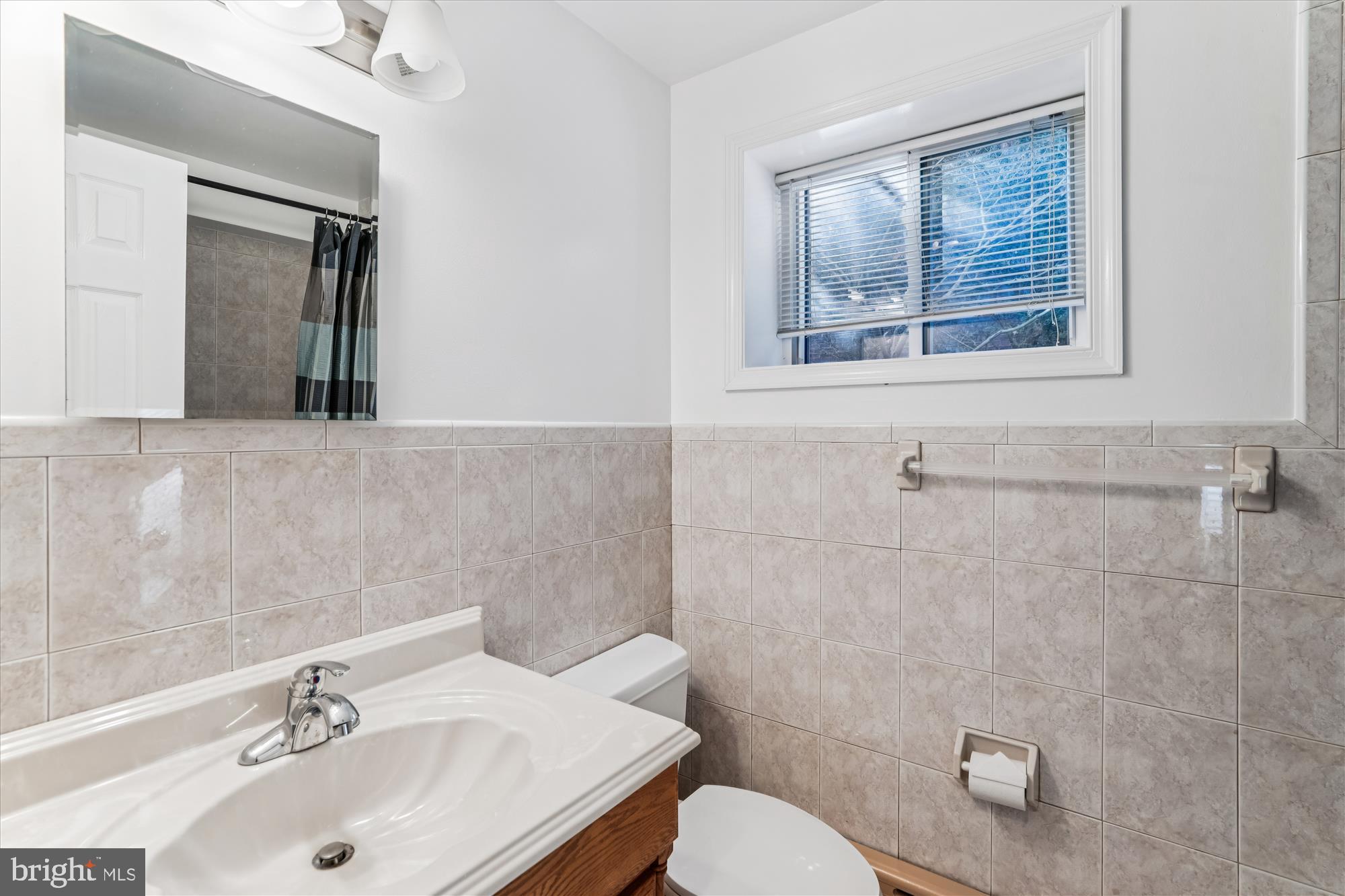 5813 Midhill Street Bethesda, MD 20817 - Photo 37 of 55 a bathroom with a sink mirror and toilet