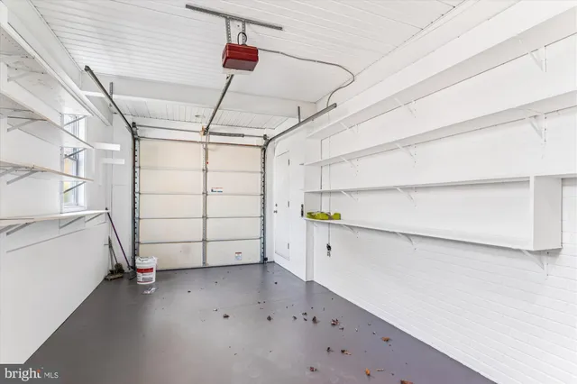 a view of a chairs and table in patio with a barbeque