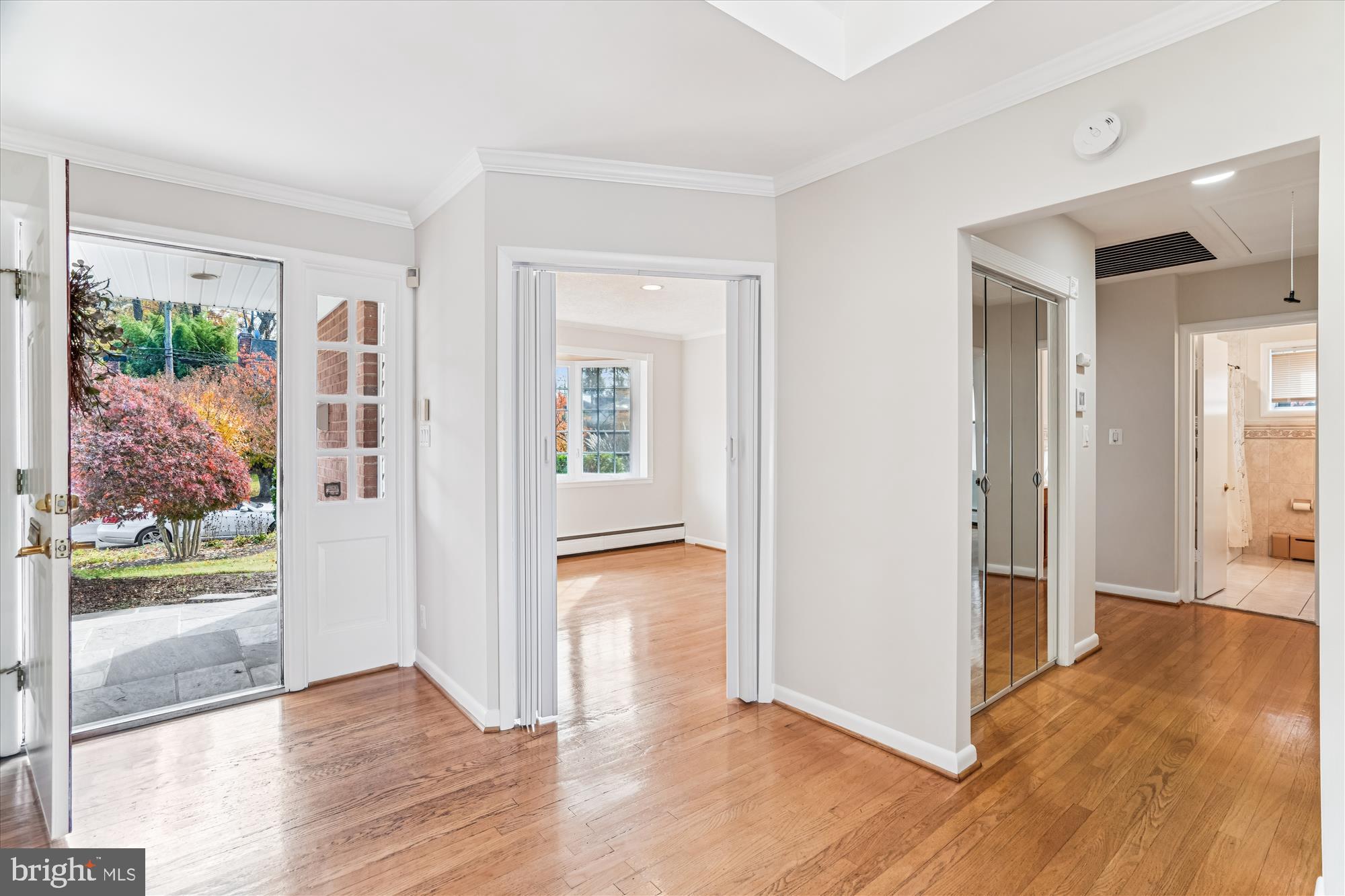 5813 Midhill Street Bethesda, MD 20817 - Photo 7 of 55 an empty room with wooden floor and a fireplace