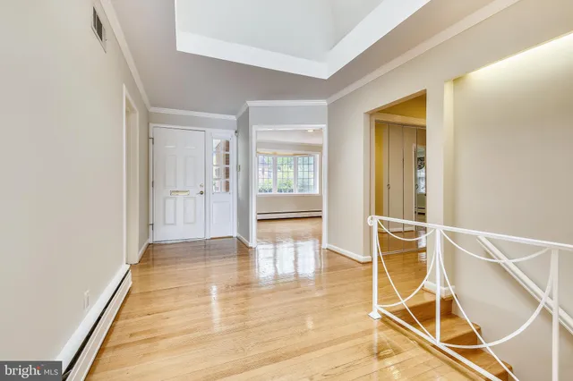 a view of empty room with wooden floor and fireplace