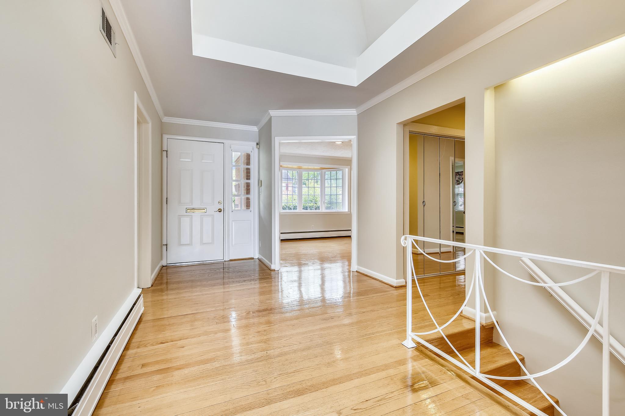 5813 Midhill Street Bethesda, MD 20817 - Photo 8 of 55 a view of an empty room with wooden floor and a window