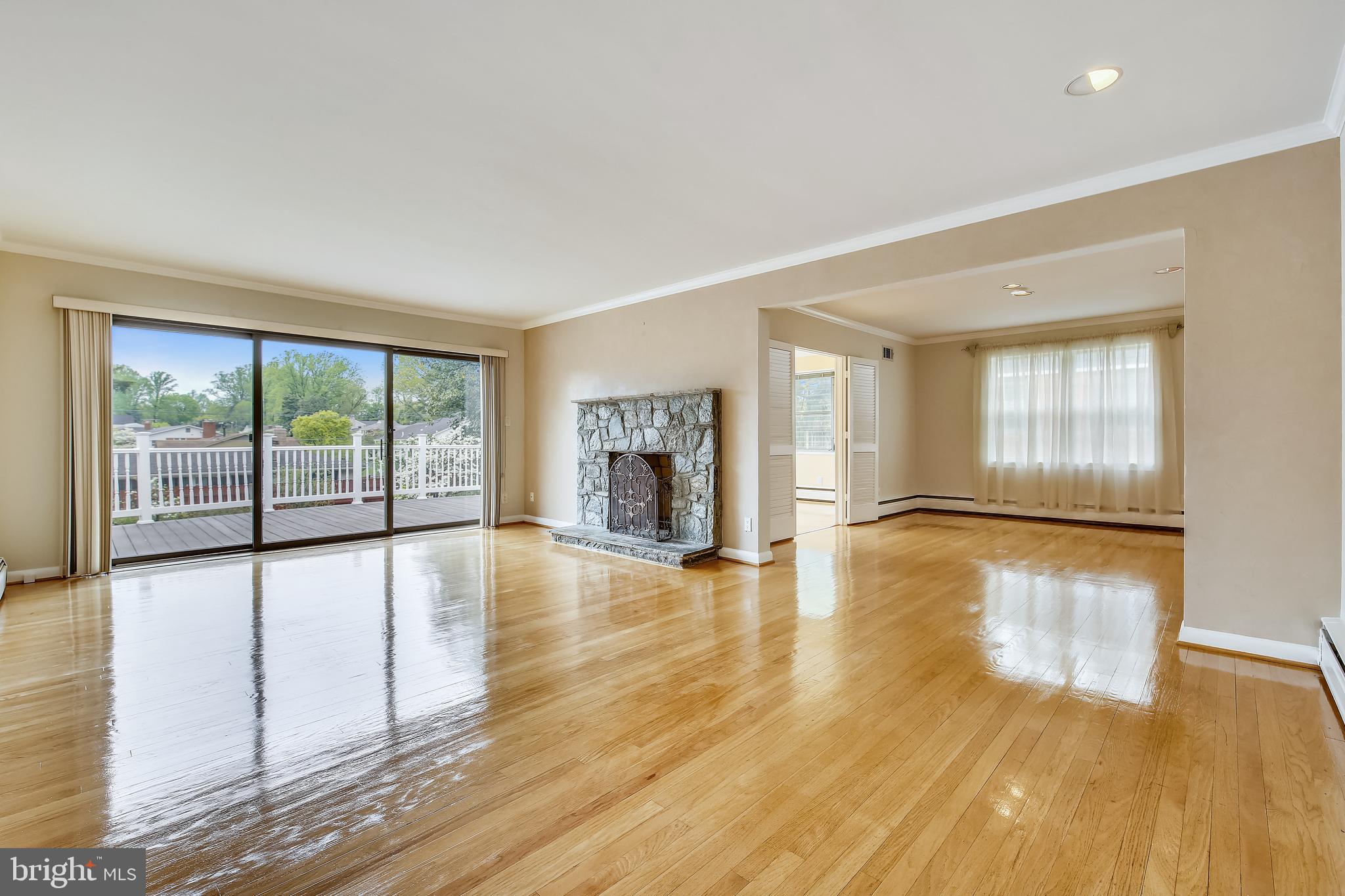 5813 Midhill Street Bethesda, MD 20817 - Photo 9 of 55 a view of empty room with wooden floor and fireplace