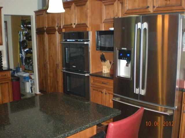 201 West Division Road Shannon, IL 61078 - Photo 4 of 12 a kitchen with stainless steel appliances granite countertop a refrigerator and a sink