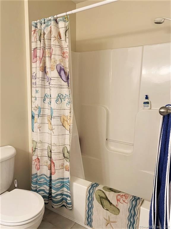 17 Spring Glen Road, Unit A East Lyme, CT 06357 - Photo 21 of 32 a white toilet sitting next to a shower curtain