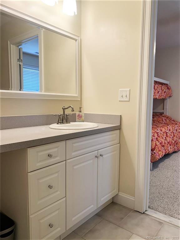17 Spring Glen Road, Unit A East Lyme, CT 06357 - Photo 22 of 32 a spacious bathroom with a sink and a mirror