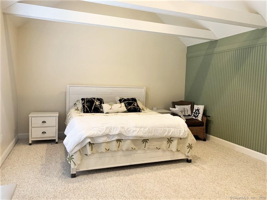 17 Spring Glen Road, Unit A East Lyme, CT 06357 - Photo 26 of 32 a bedroom with a bed and a night stand