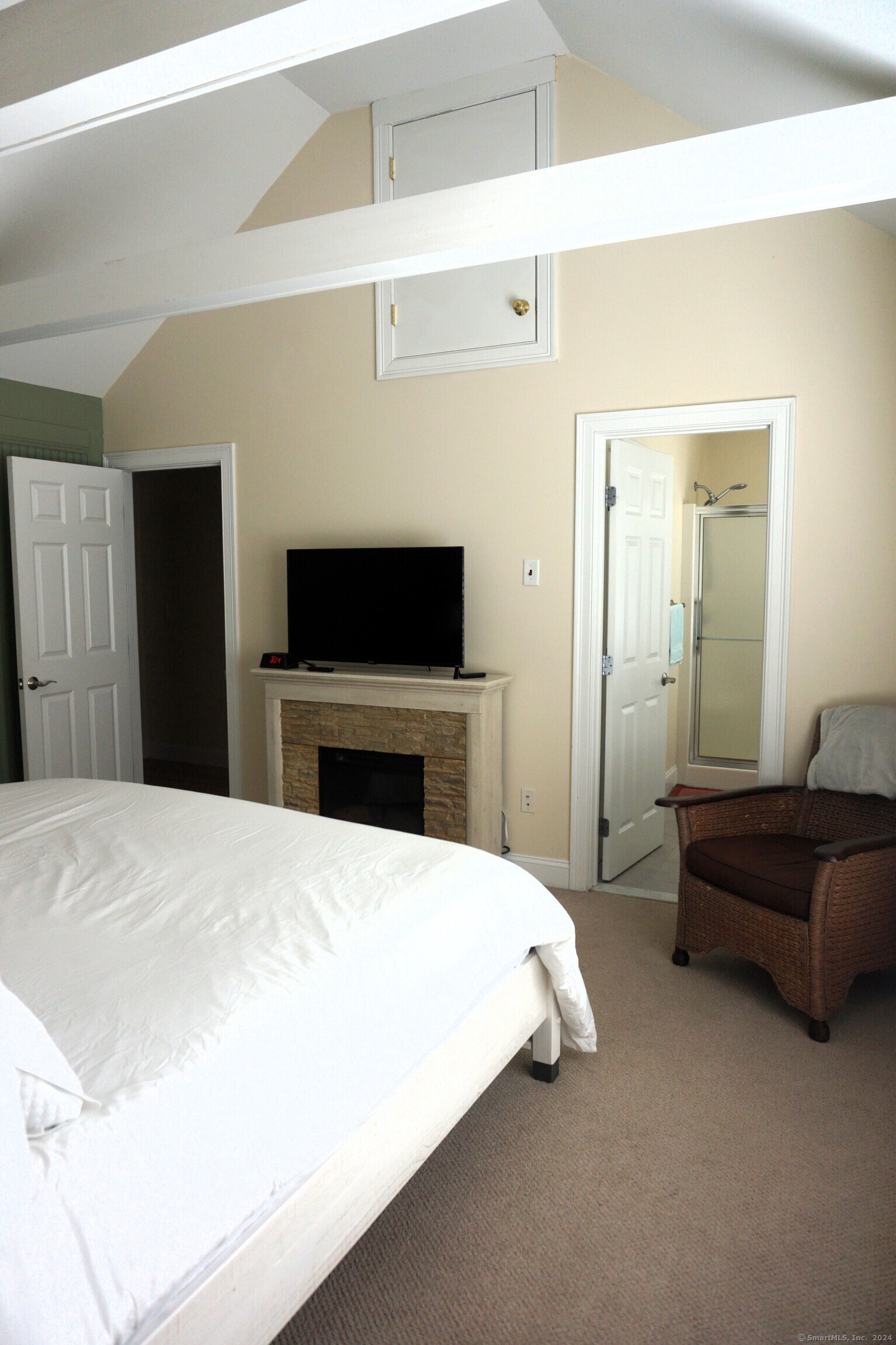 17 Spring Glen Road, Unit A East Lyme, CT 06357 - Photo 28 of 32 a bedroom with a bed and a flat screen tv