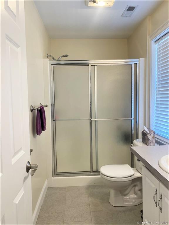 17 Spring Glen Road, Unit A East Lyme, CT 06357 - Photo 29 of 32 a bathroom with a toilet a sink and shower