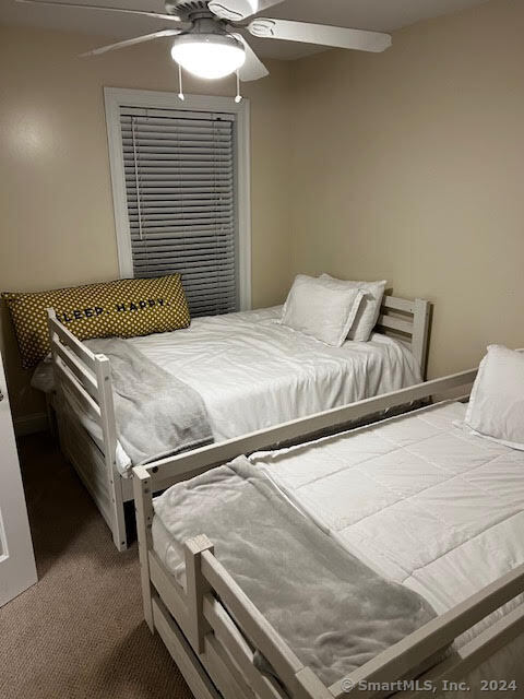 17 Spring Glen Road, Unit A East Lyme, CT 06357 - Photo 30 of 32 a bedroom with a bed and a chandelier