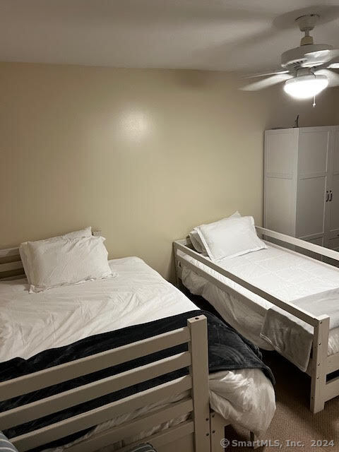 17 Spring Glen Road, Unit A East Lyme, CT 06357 - Photo 31 of 32 a bedroom with a bed and a lamp