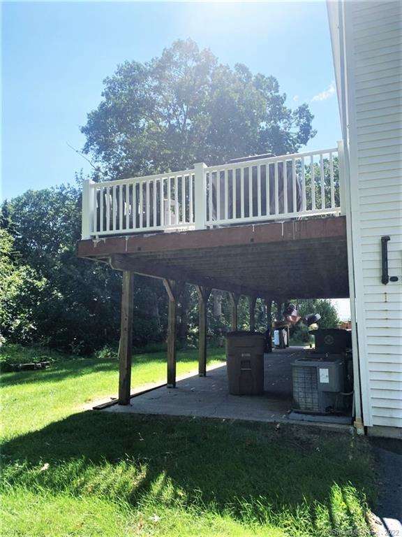 17 Spring Glen Road, Unit A East Lyme, CT 06357 - Photo 4 of 32 a view of a chair and table in the garden