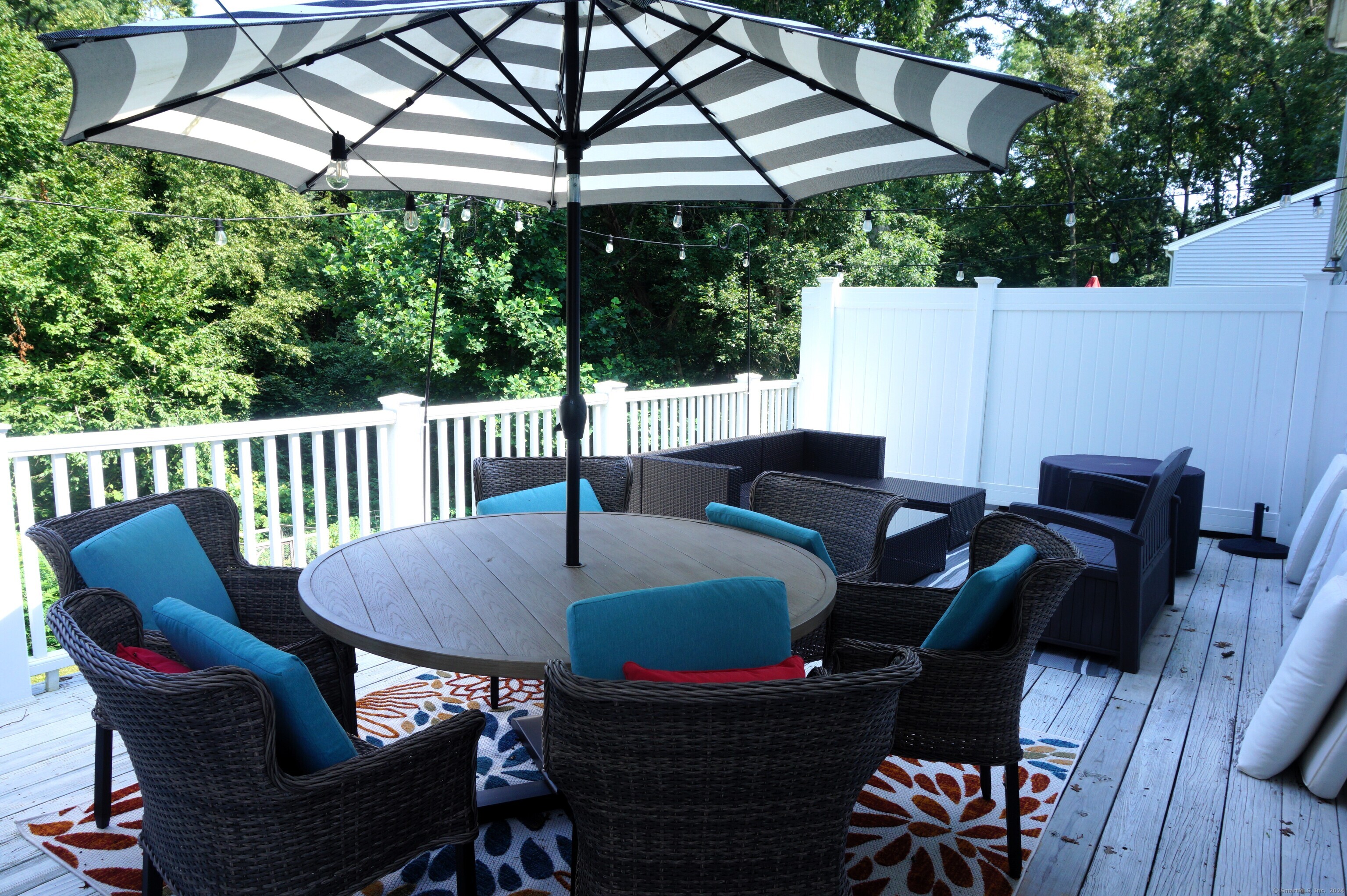 17 Spring Glen Road, Unit A East Lyme, CT 06357 - Photo 7 of 32 a patio table with chairs and an umbrella