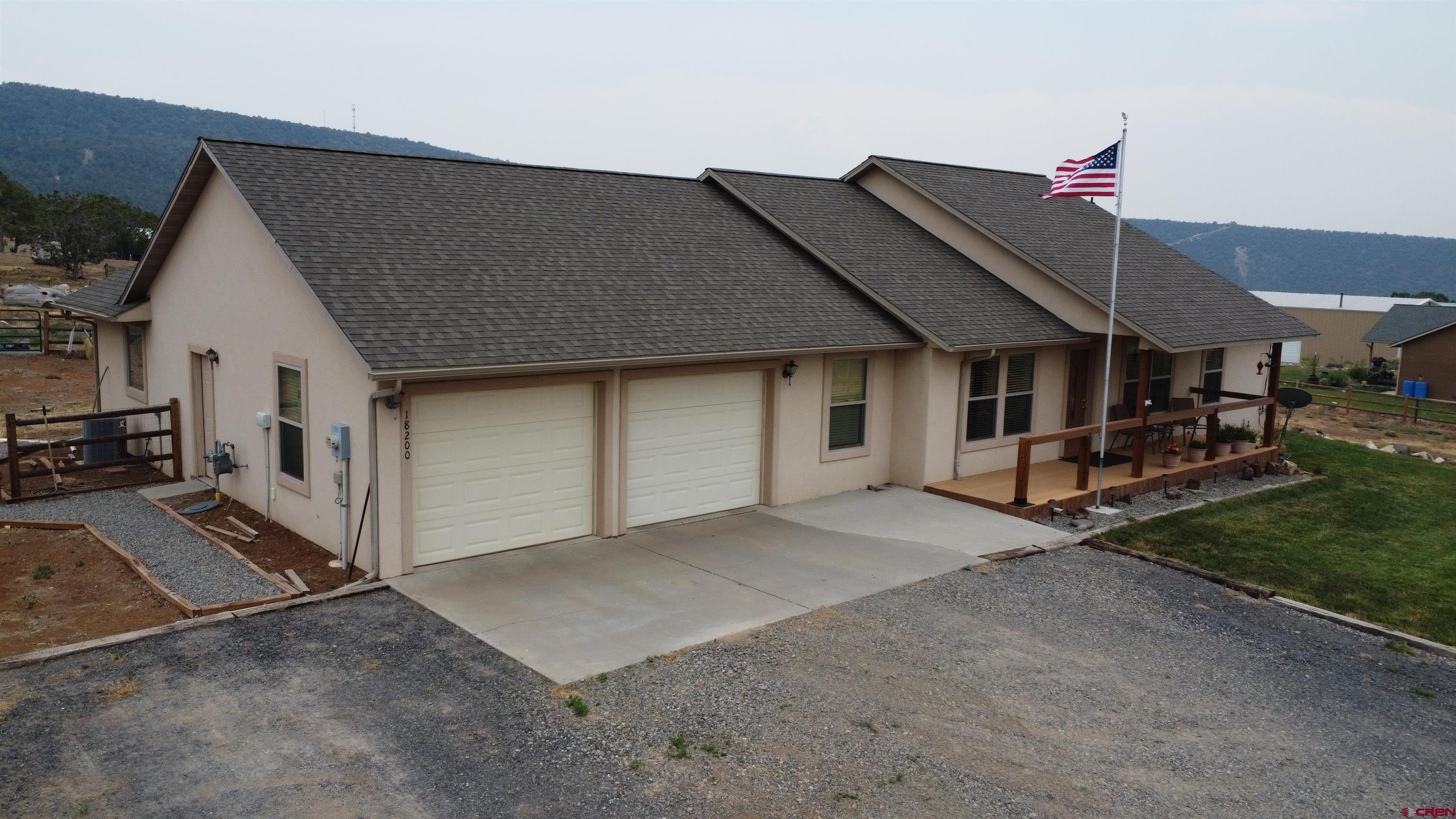 18200 Surface Creek Road Cedaredge, CO 81413 - Photo 12 of 39 a view of a house with backyard and porch