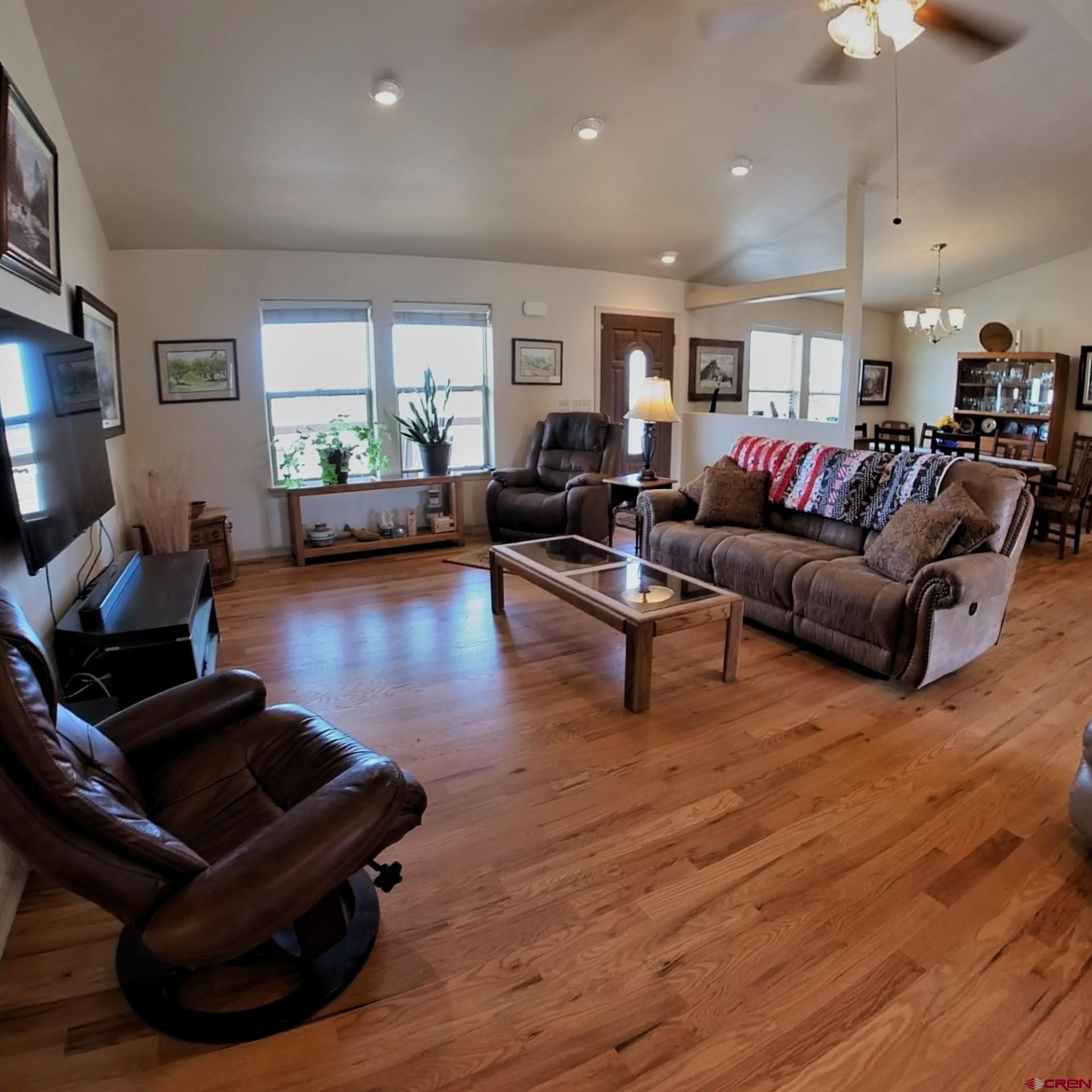 18200 Surface Creek Road Cedaredge, CO 81413 - Photo 13 of 39 a living room with furniture and a wooden floor