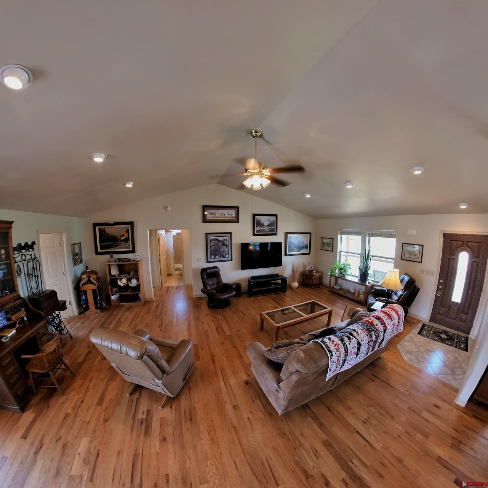 18200 Surface Creek Road Cedaredge, CO 81413 - Photo 15 of 39 a living room with furniture hard wood floor and a flat screen tv