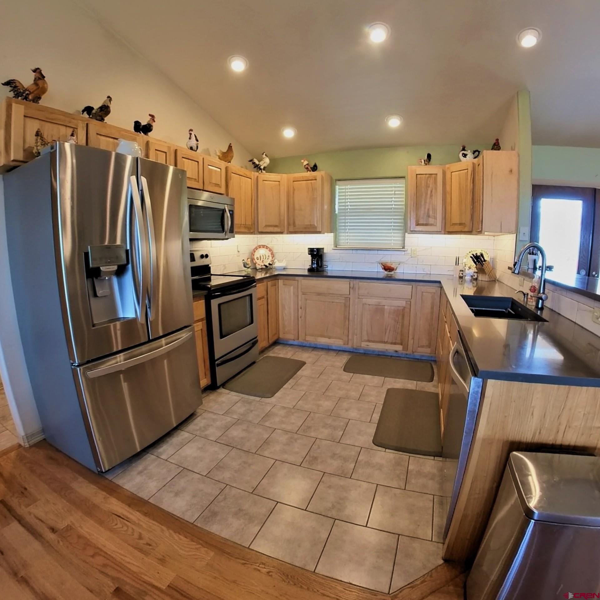 18200 Surface Creek Road Cedaredge, CO 81413 - Photo 20 of 39 a kitchen with stainless steel appliances granite countertop a refrigerator and a sink