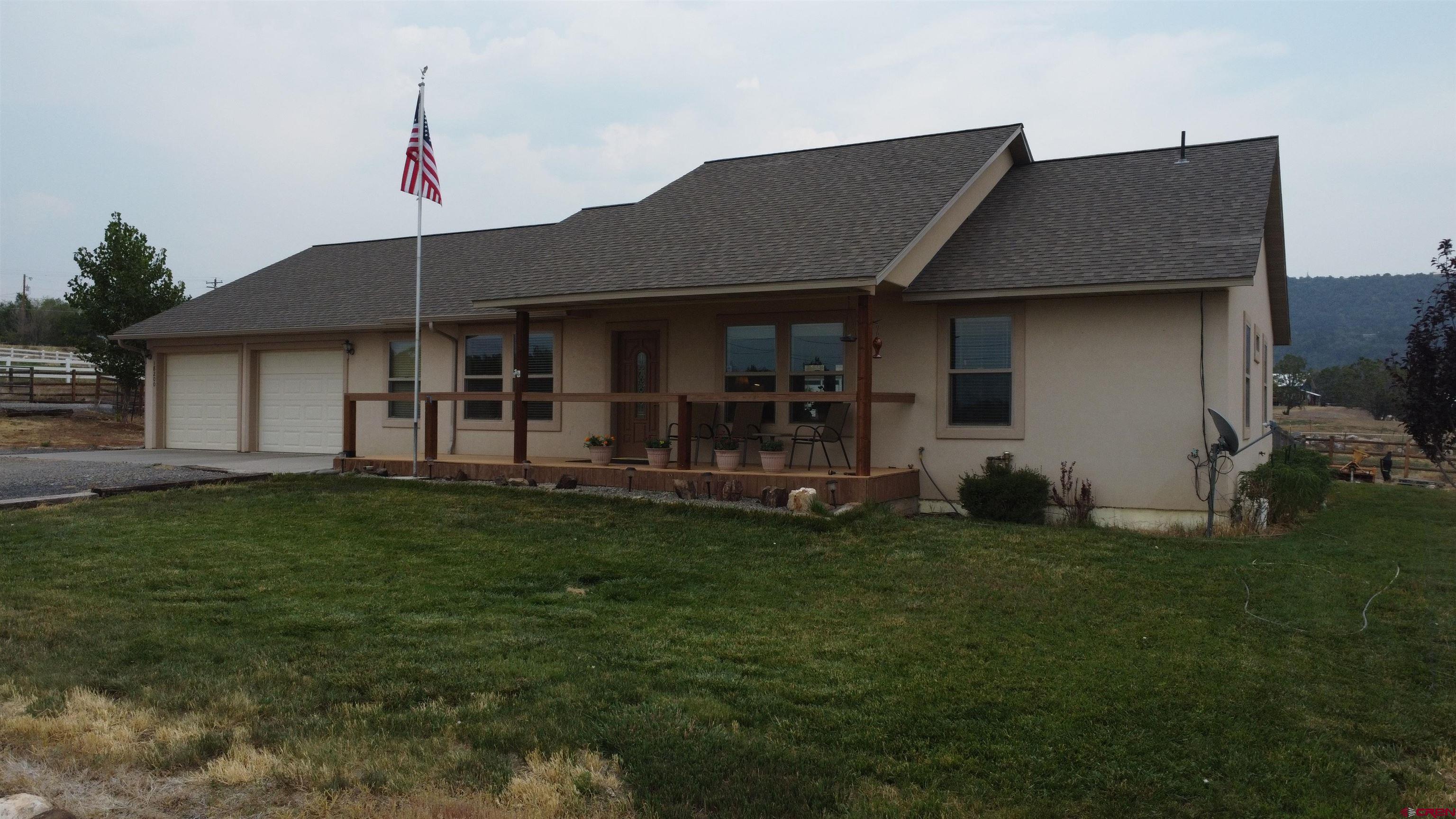 18200 Surface Creek Road Cedaredge, CO 81413 - Photo 2 of 39 a house view with a garden space