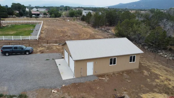 an aerial view of a house with a yard