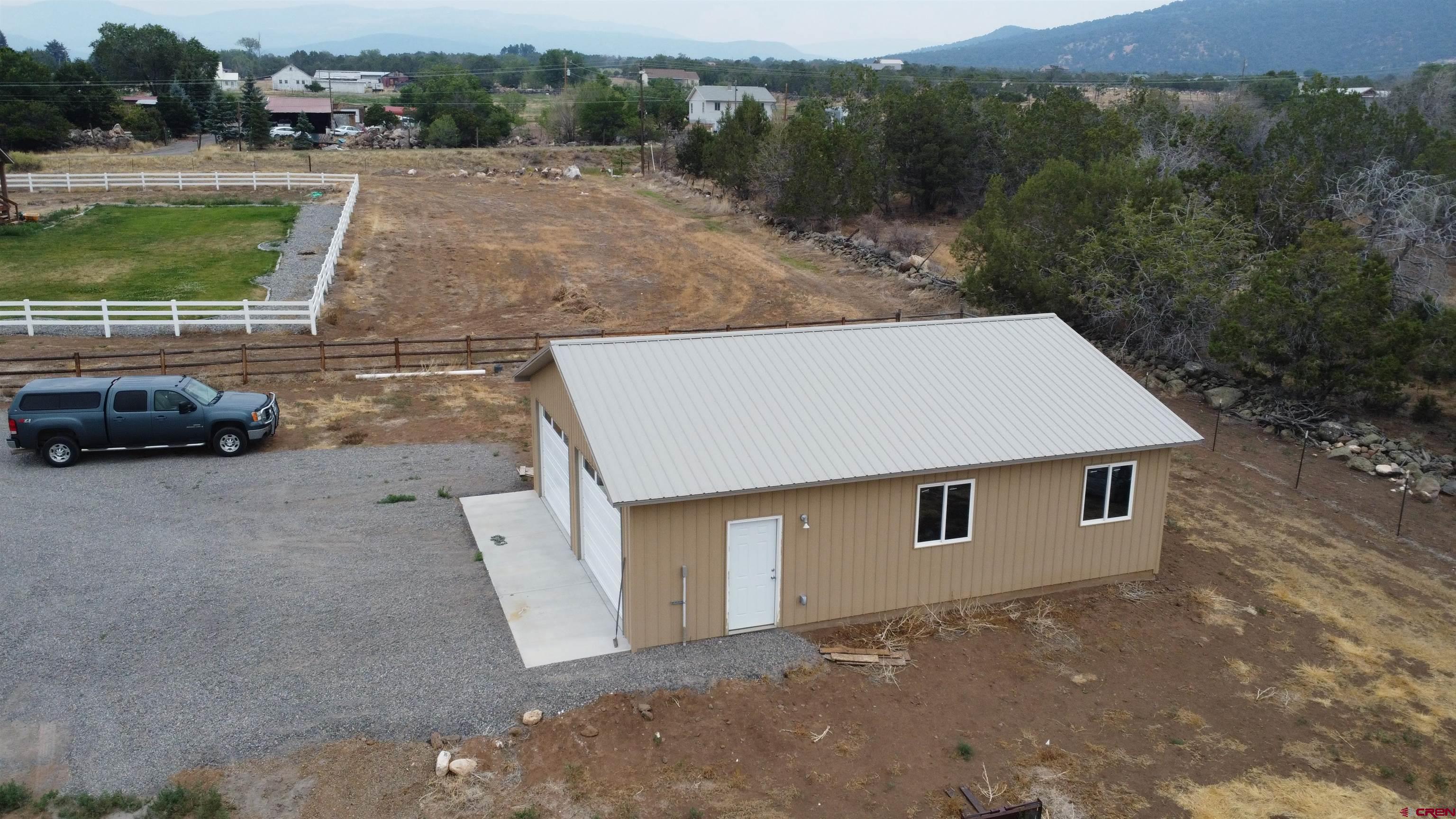 18200 Surface Creek Road Cedaredge, CO 81413 - Photo 2 of 39 an aerial view of a house with a yard