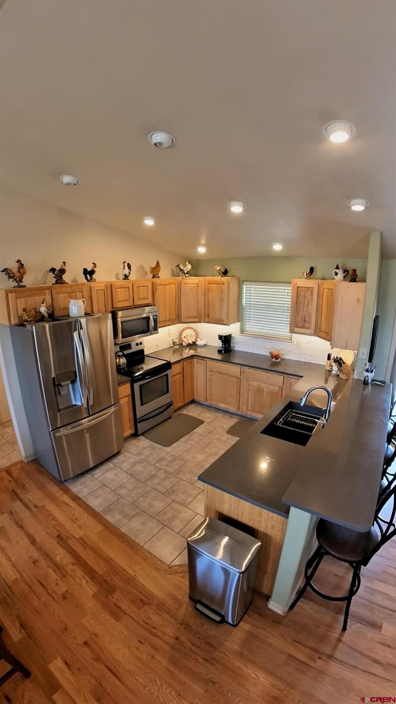 18200 Surface Creek Road Cedaredge, CO 81413 - Photo 21 of 39 a living room with stainless steel appliances furniture or kitchen and a wooden floor