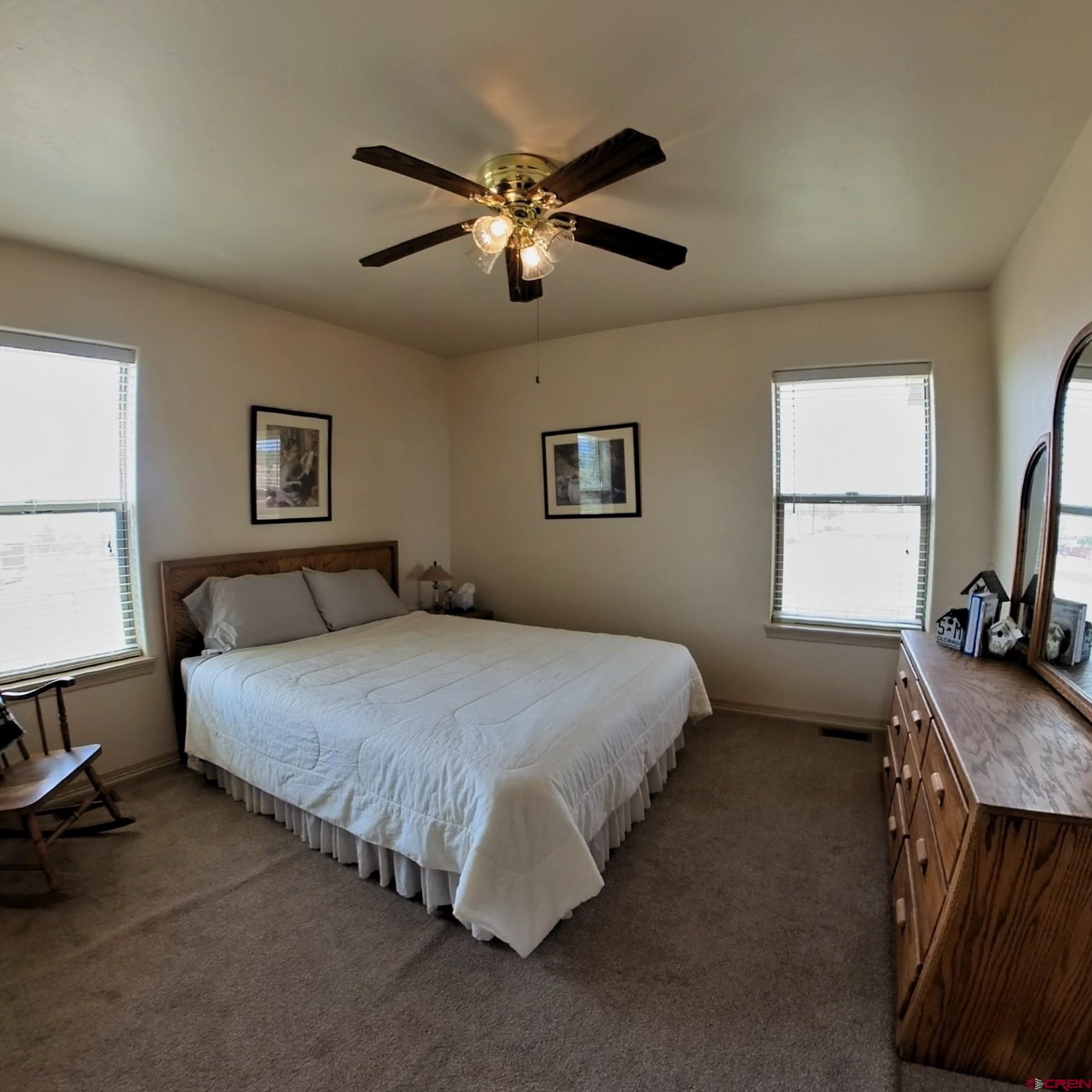 18200 Surface Creek Road Cedaredge, CO 81413 - Photo 22 of 39 a bedroom with a bed and window