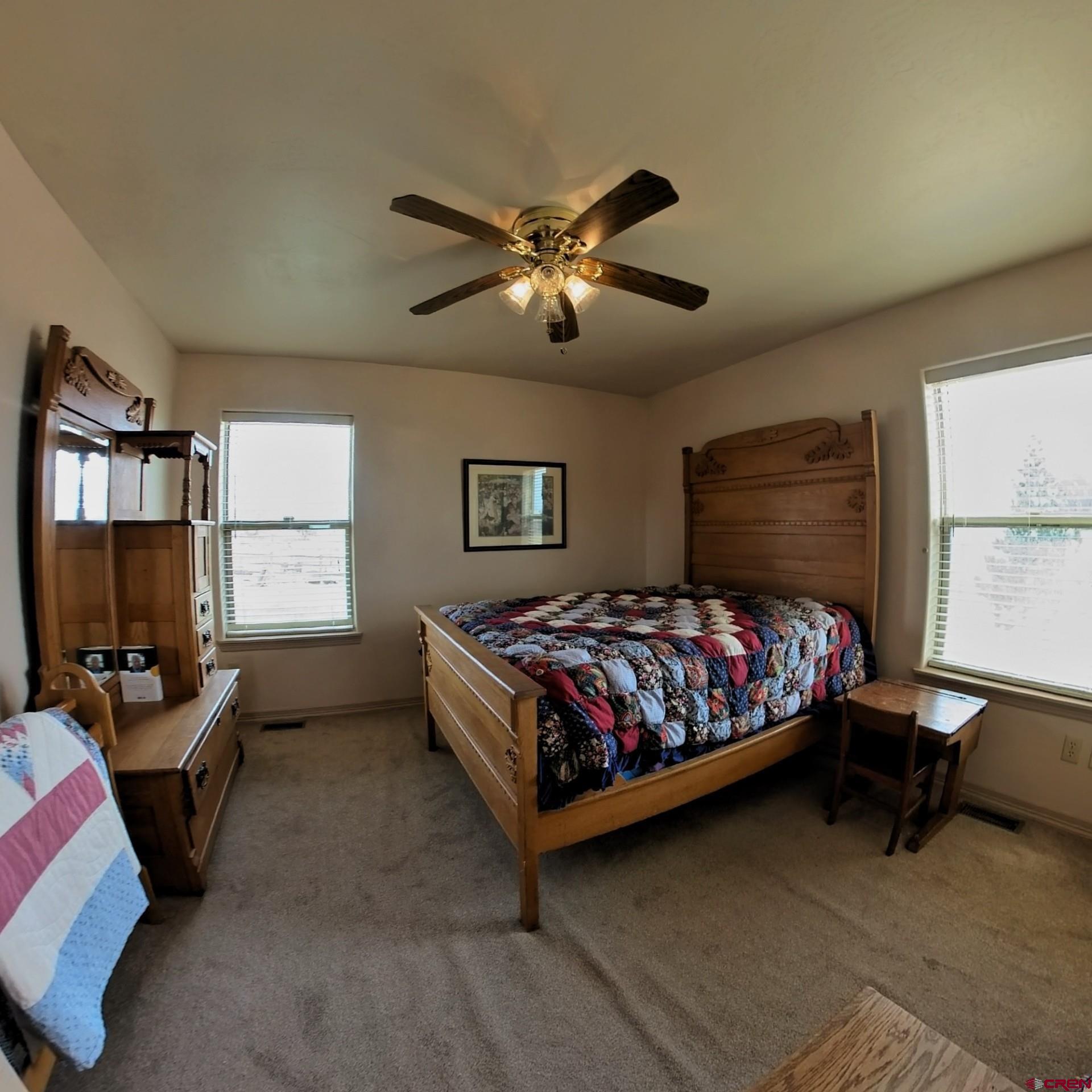 18200 Surface Creek Road Cedaredge, CO 81413 - Photo 28 of 39 a bedroom with a bed work place window and a desk