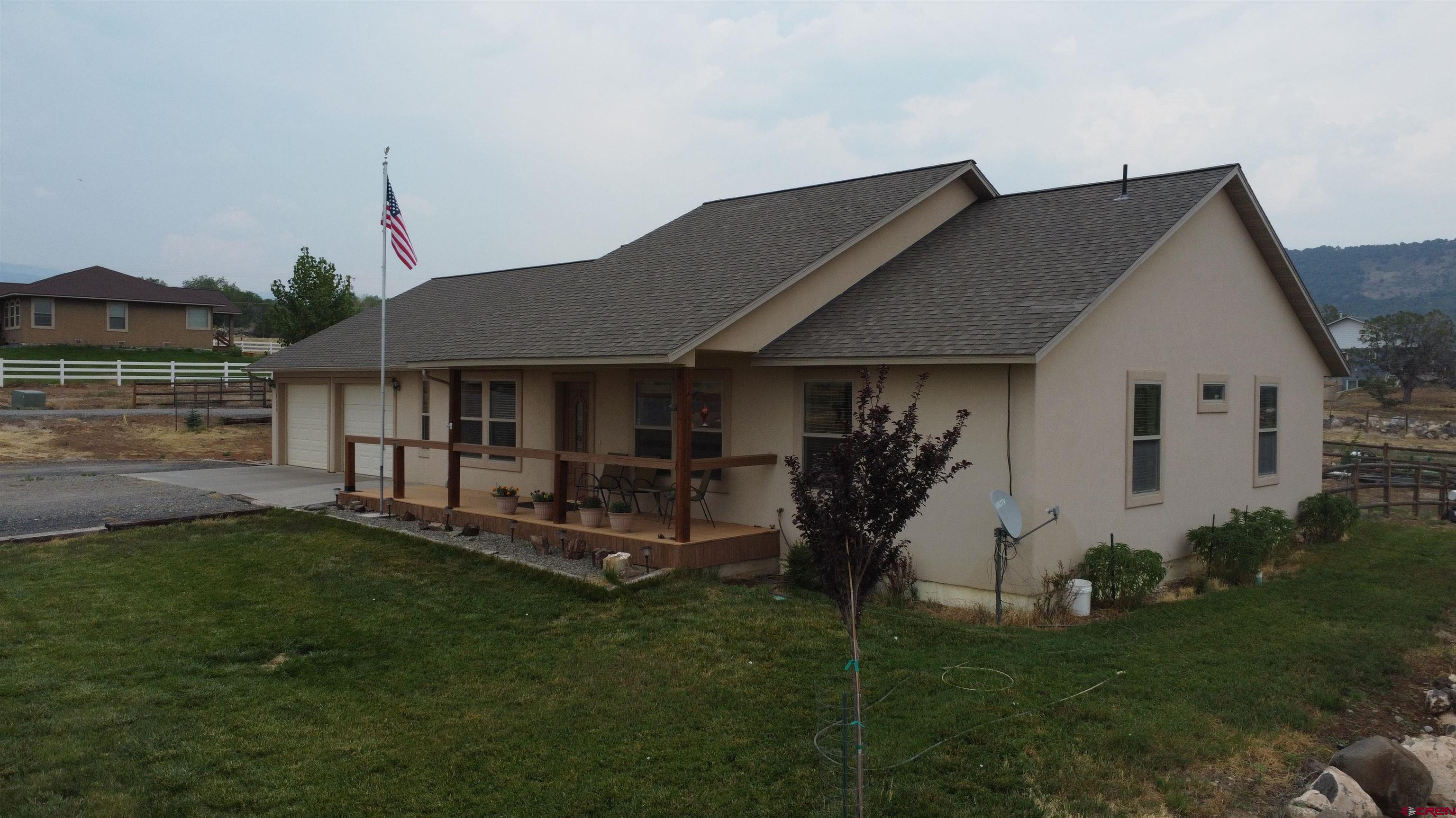 18200 Surface Creek Road Cedaredge, CO 81413 - Photo 32 of 39 a front view of a house with a garden