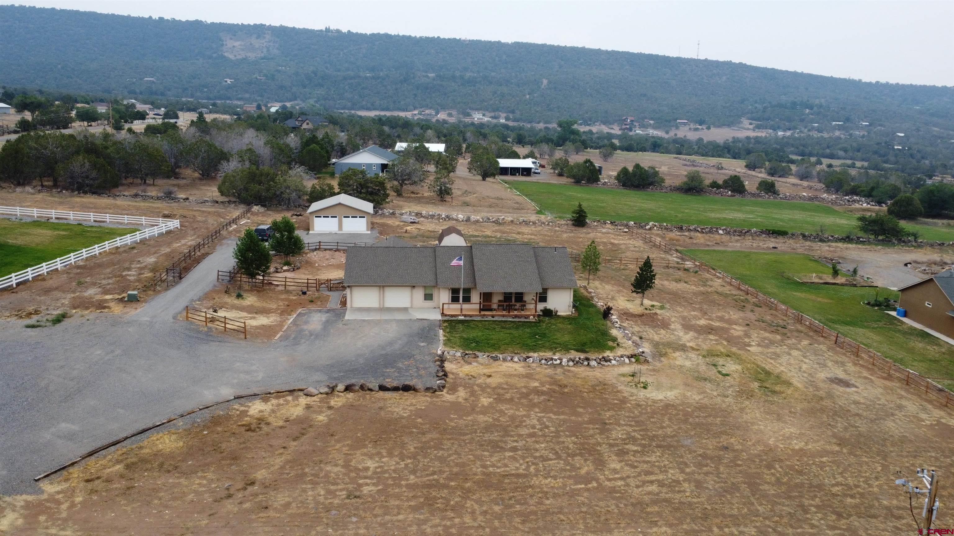 18200 Surface Creek Road Cedaredge, CO 81413 - Photo 33 of 39 an aerial view of a house with a yard