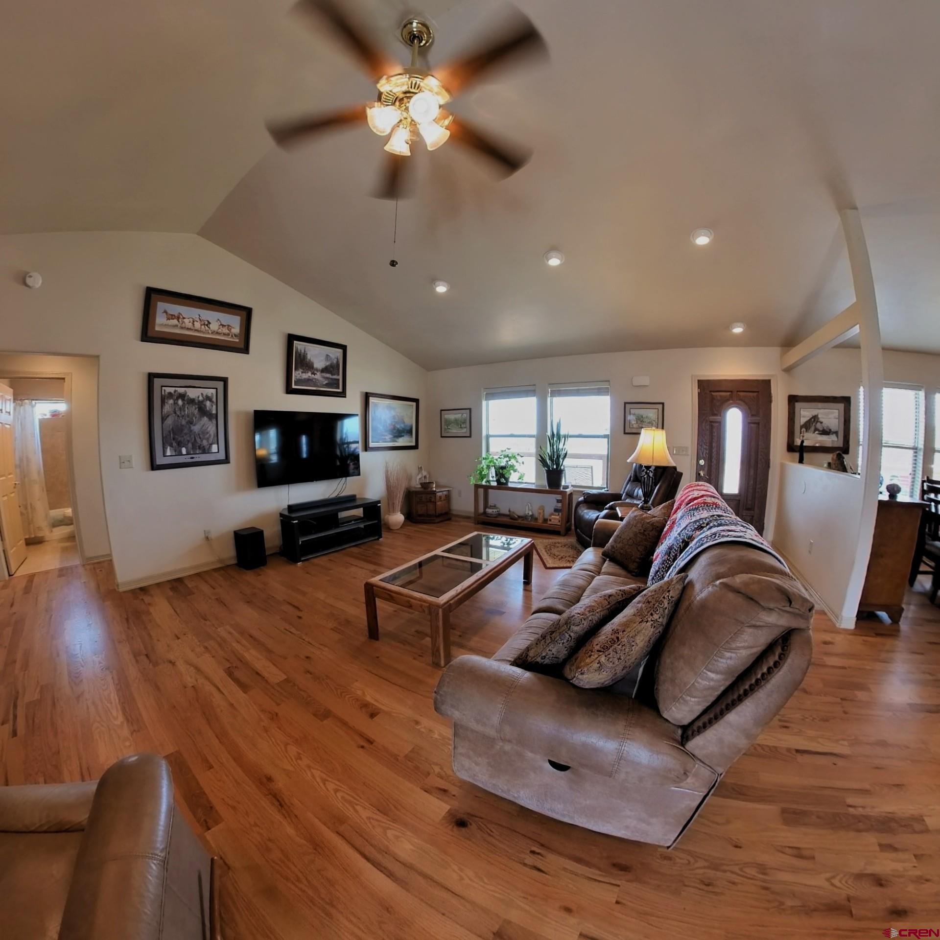 18200 Surface Creek Road Cedaredge, CO 81413 - Photo 34 of 39 a living room with furniture flat screen tv and wooden floor