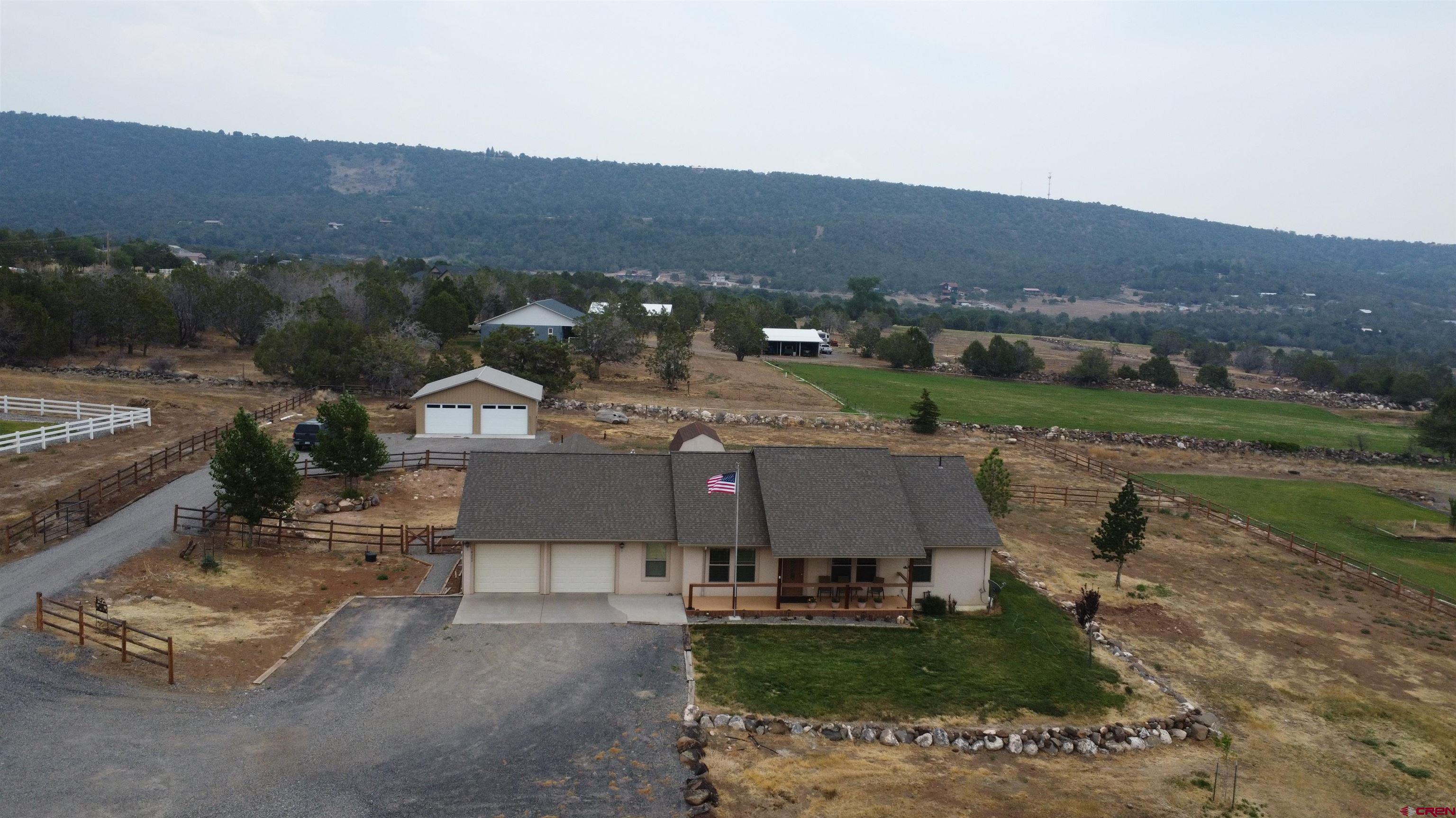18200 Surface Creek Road Cedaredge, CO 81413 - Photo 35 of 39 an aerial view of a house with a garden
