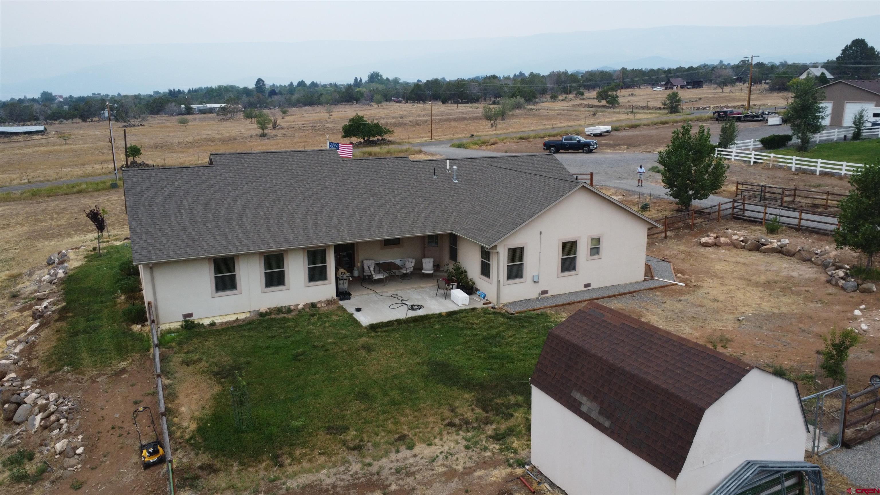 18200 Surface Creek Road Cedaredge, CO 81413 - Photo 36 of 39 a aerial view of a house with a yard and lake view