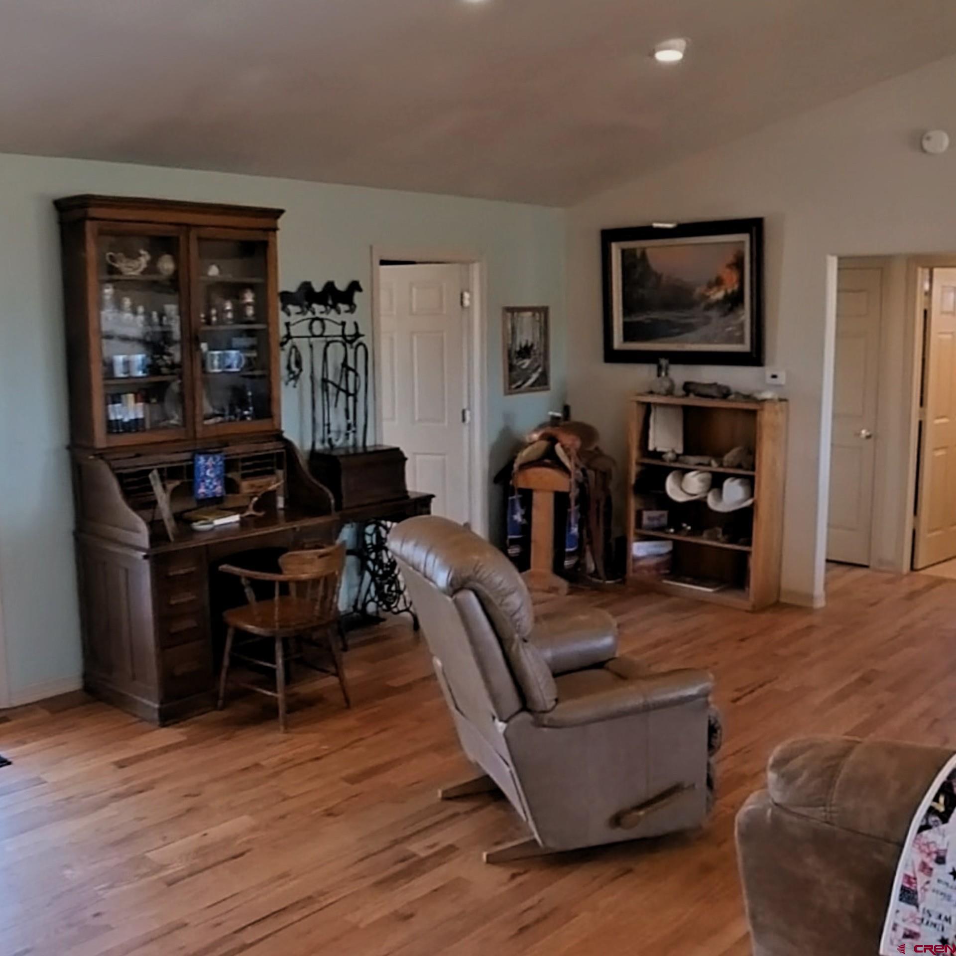 18200 Surface Creek Road Cedaredge, CO 81413 - Photo 36 of 39 a living room with furniture and a flat screen tv