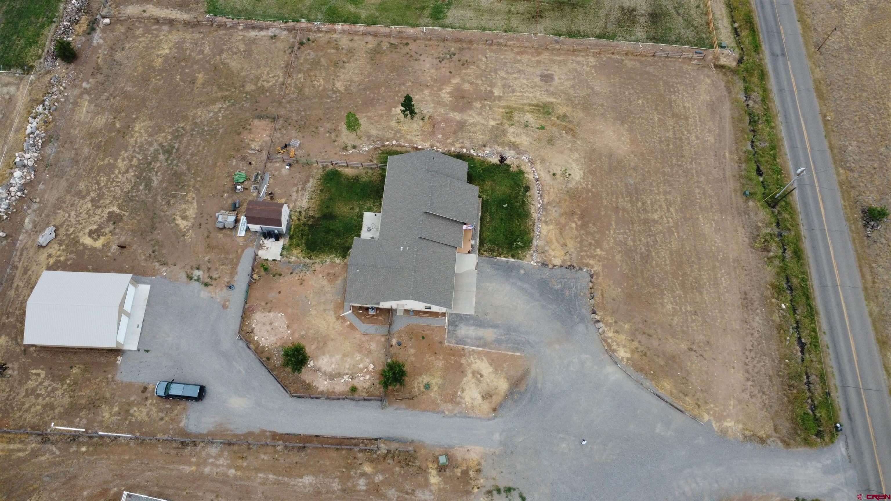 18200 Surface Creek Road Cedaredge, CO 81413 - Photo 37 of 39 an aerial view of a house with a yard