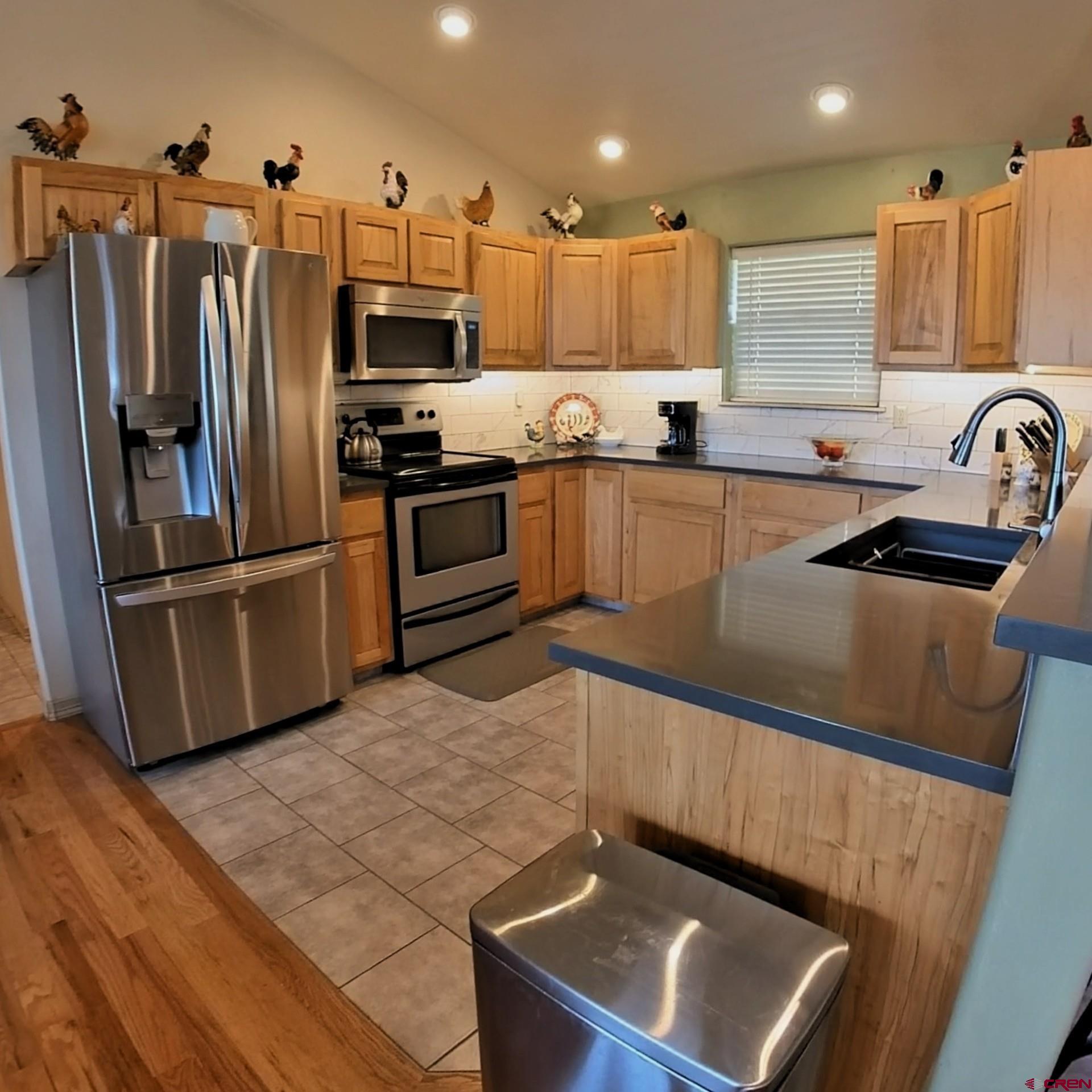 18200 Surface Creek Road Cedaredge, CO 81413 - Photo 39 of 39 a kitchen with granite countertop a refrigerator and a sink