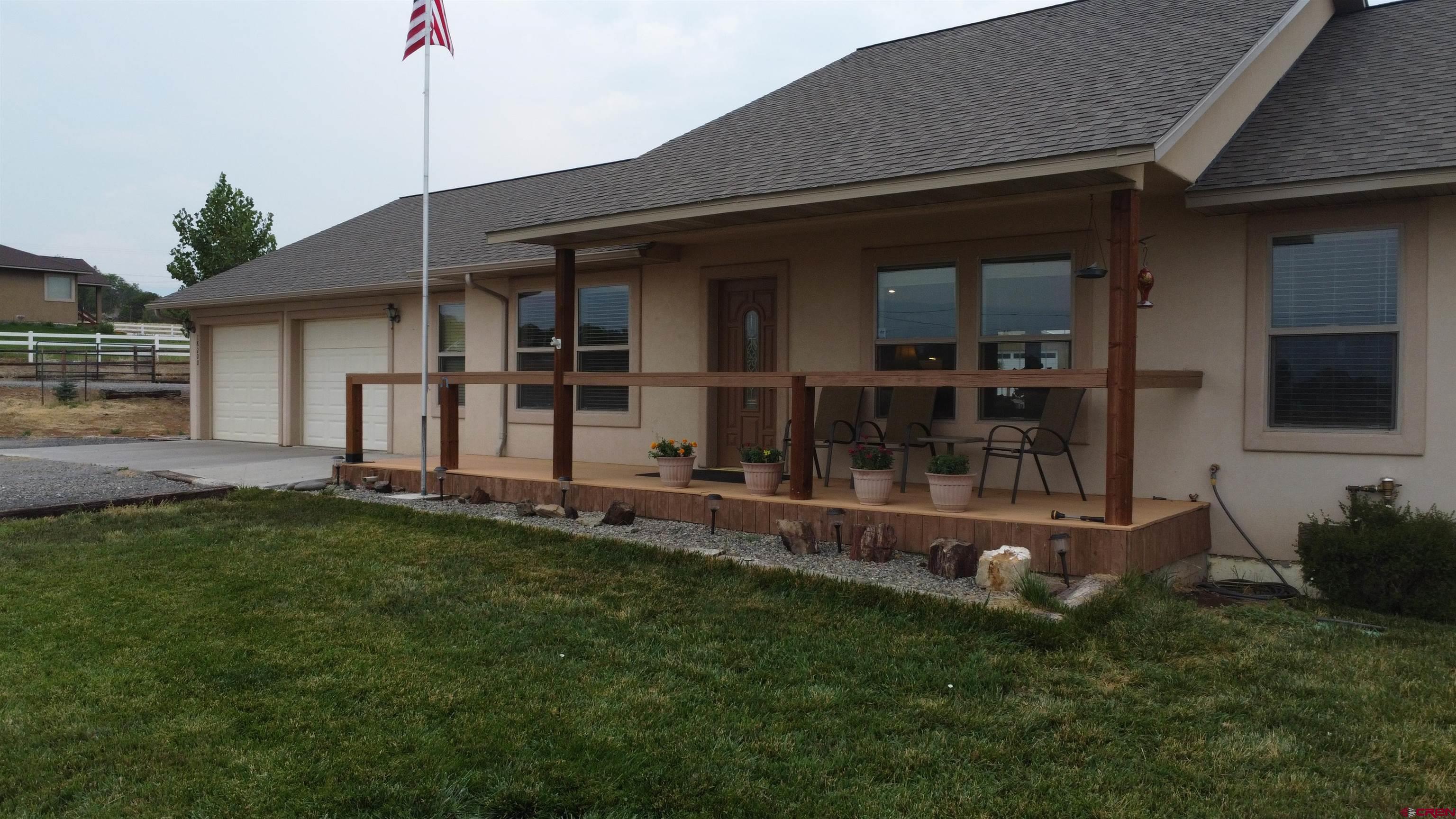 18200 Surface Creek Road Cedaredge, CO 81413 - Photo 4 of 39 a front view of a house with a garden